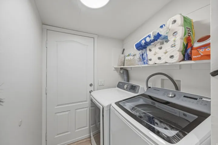 Laundry room with washer and clothes dryer