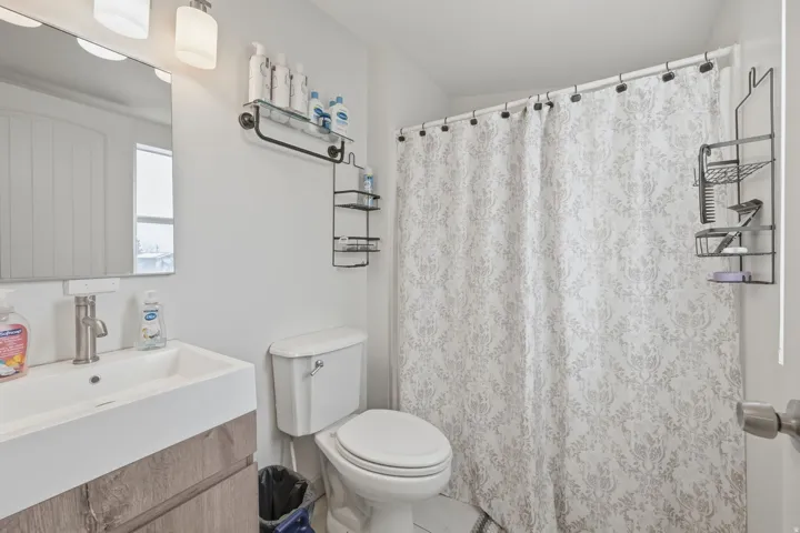 Bathroom with vanity and curtained shower