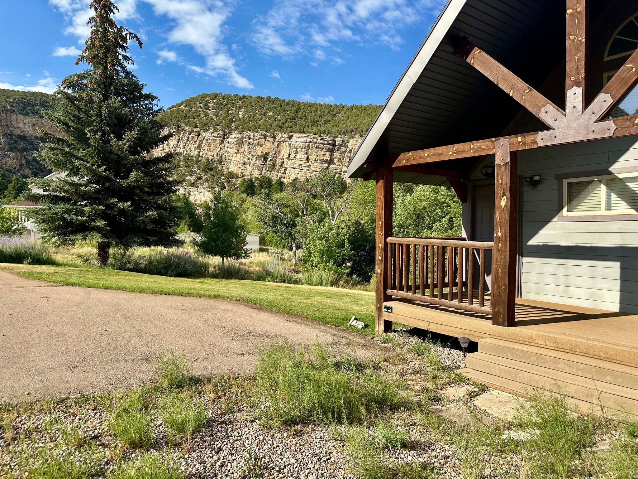 View of side of home with a deck with mountain view