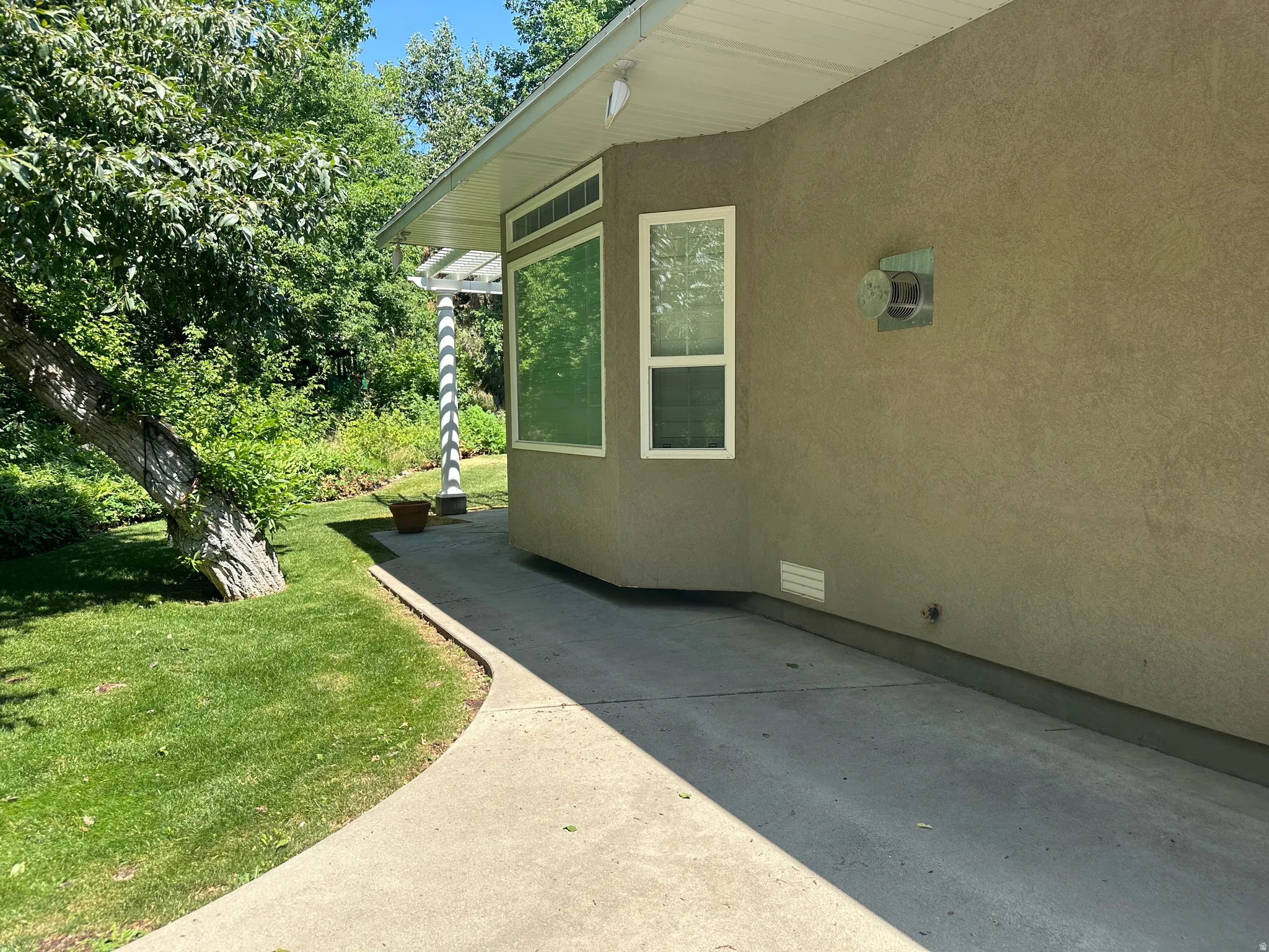 View of side of property with a lawn, crawl space, and stucco siding