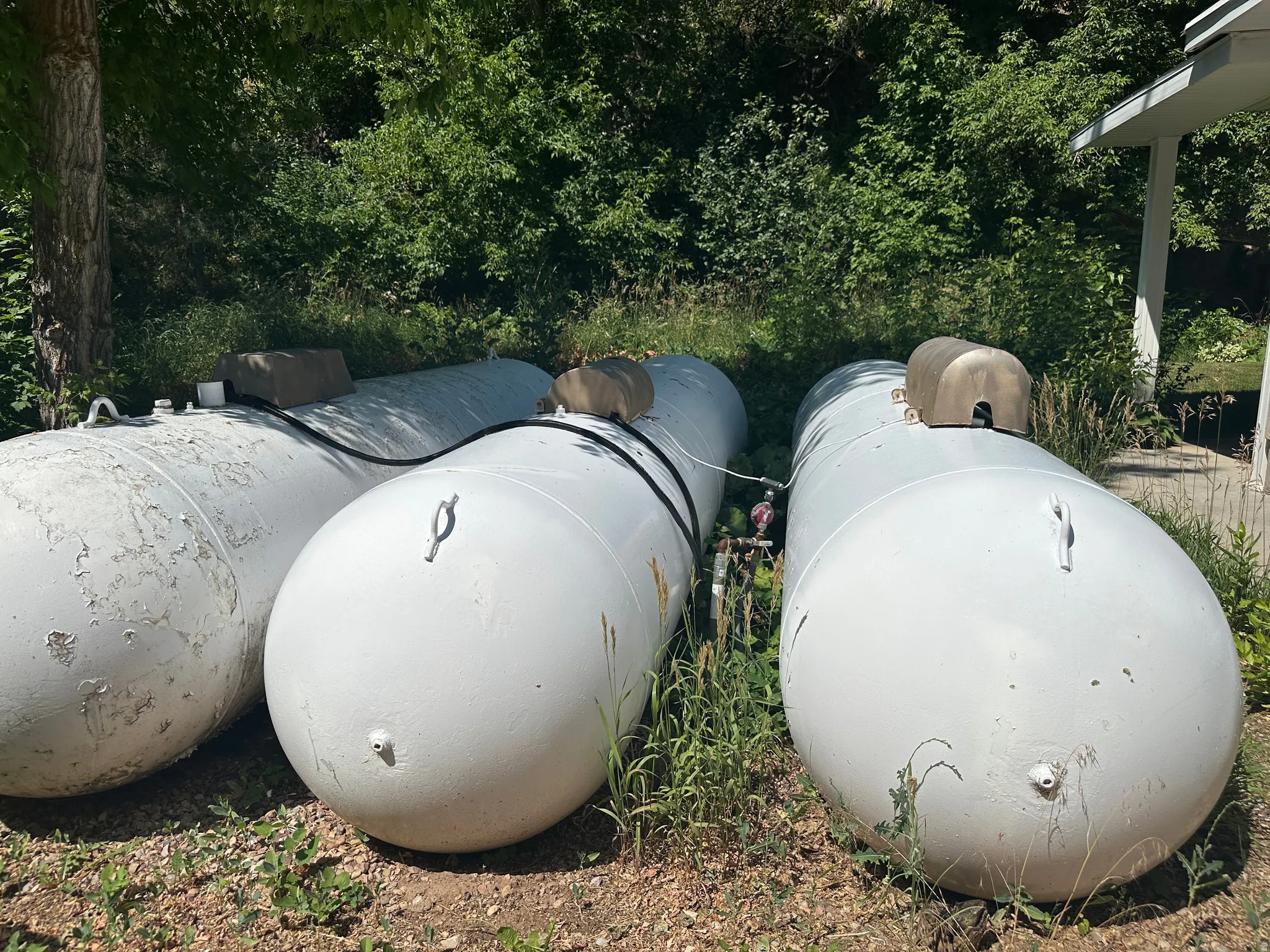 Three 1,000 gallon propane tanks