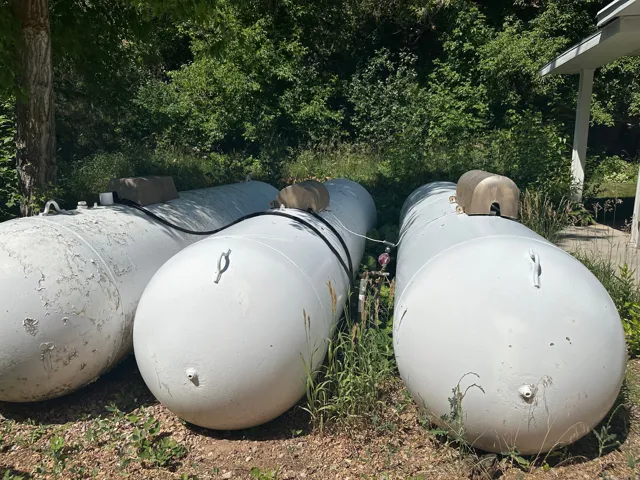 Three 1,000 gallon propane tanks