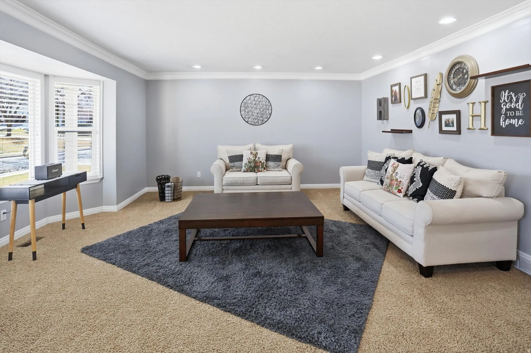Carpeted living room featuring ornamental molding and recessed lighting
