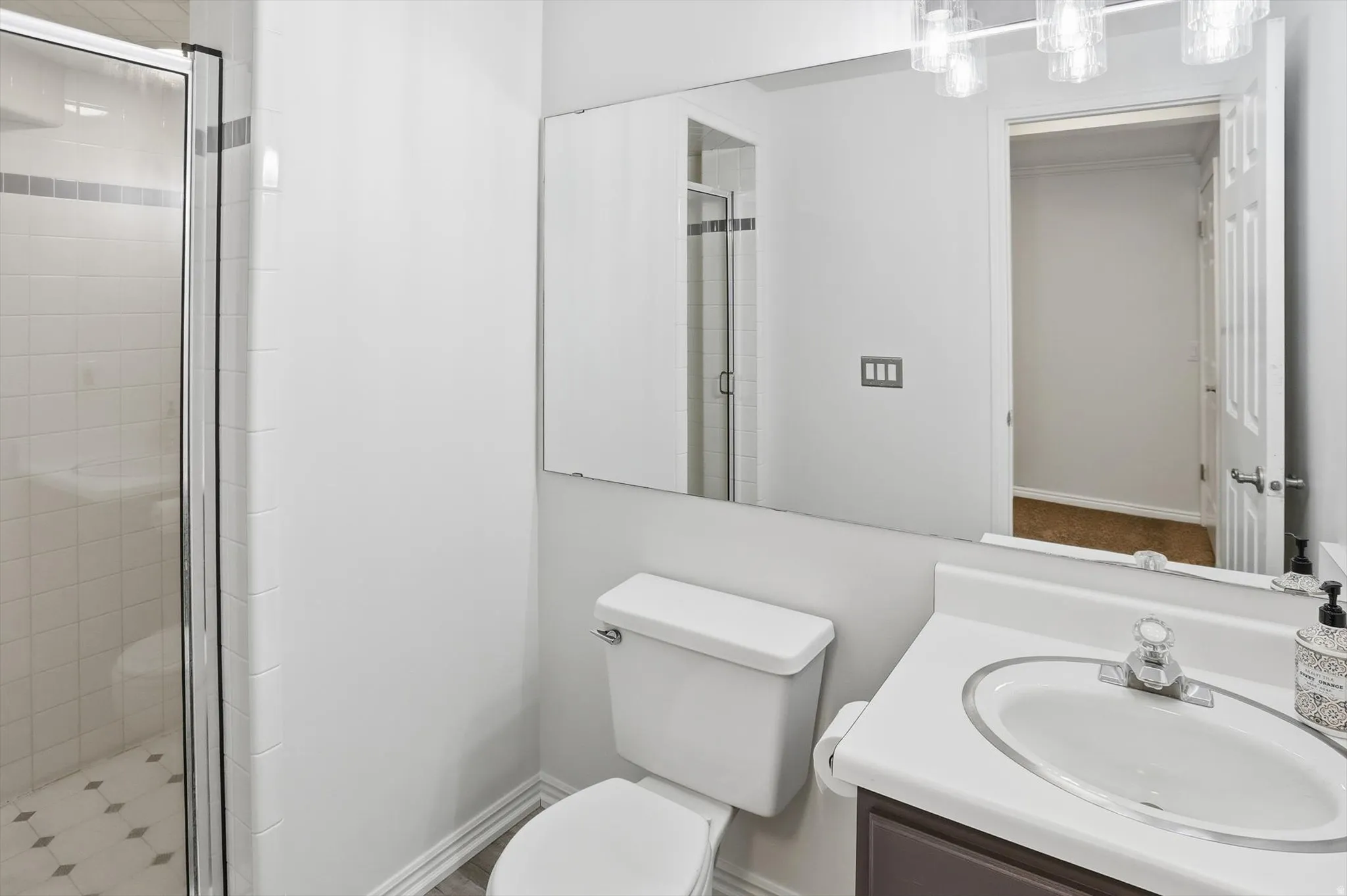 Bathroom featuring vanity and a stall shower