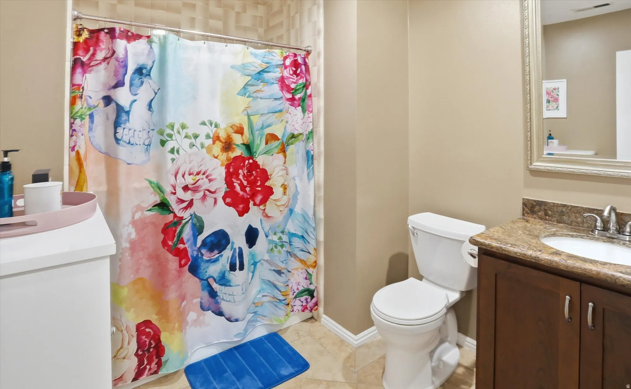 Bathroom featuring vanity, a shower with curtain, and light tile patterned floors