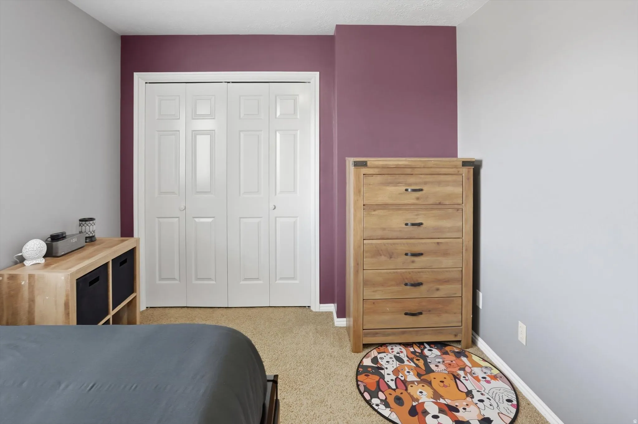 Bedroom with light carpet and a closet
