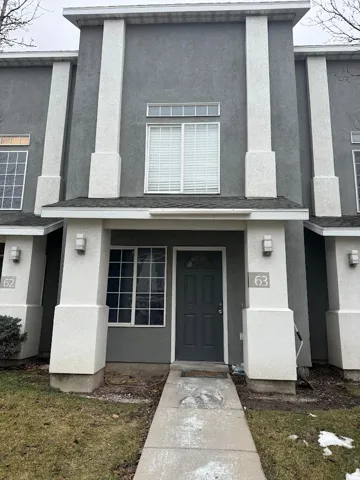 Doorway to property with stucco siding