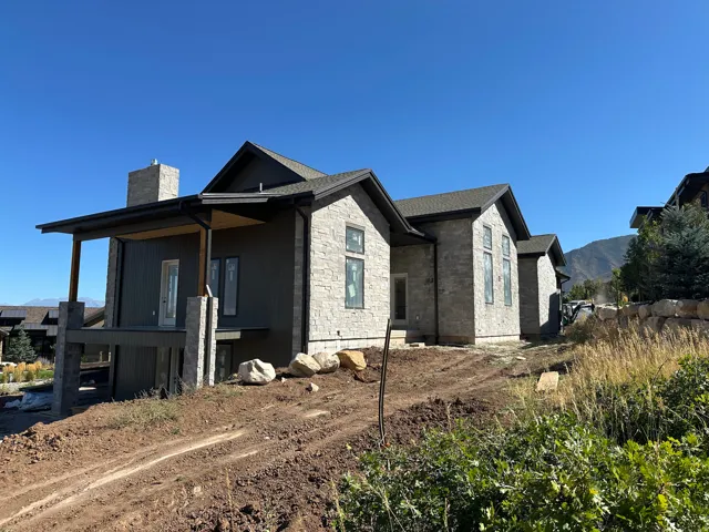 Stone and vertical siding exterior with a covered porch