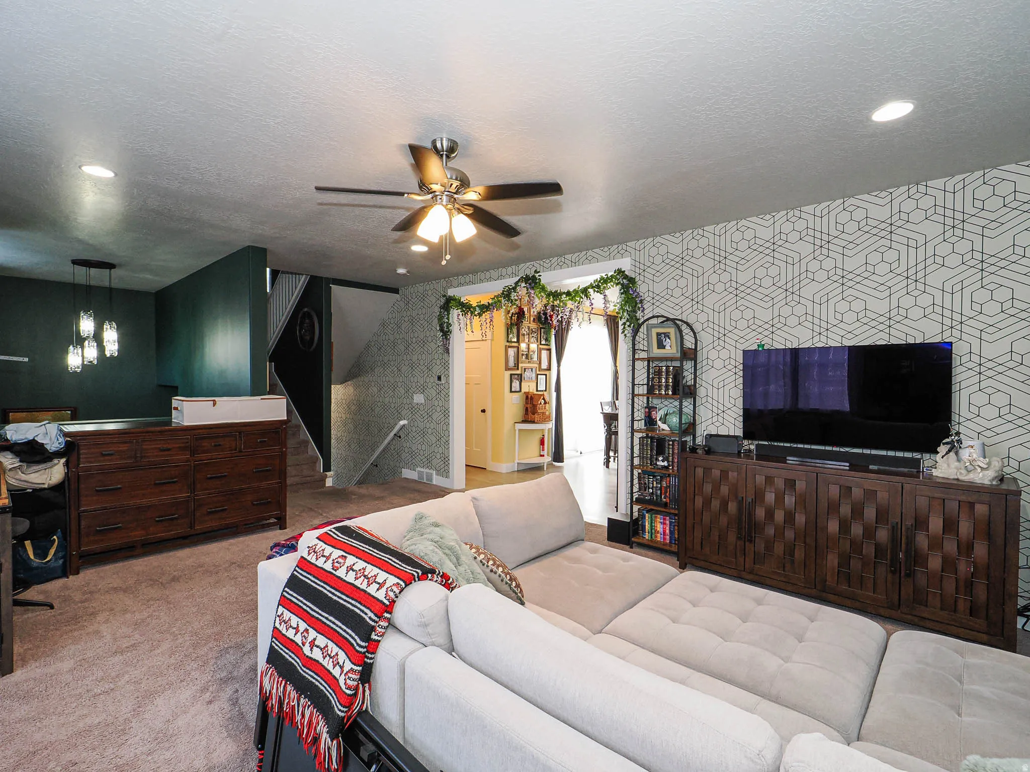Bedroom featuring light colored carpet, ceiling fan, wallpapered walls, recessed lighting, and a textured ceiling