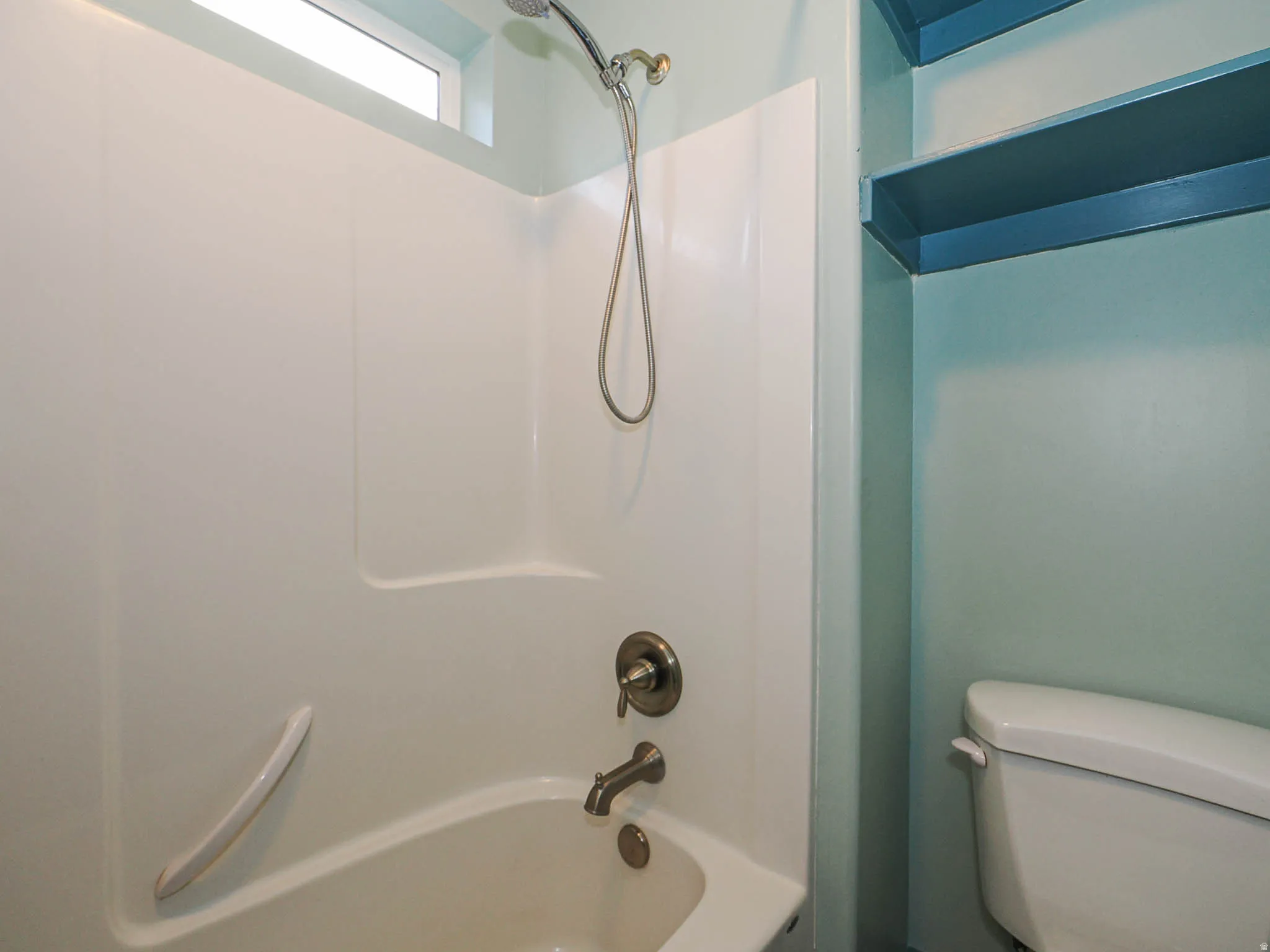 Bathroom with toilet and shower / bathtub combination
