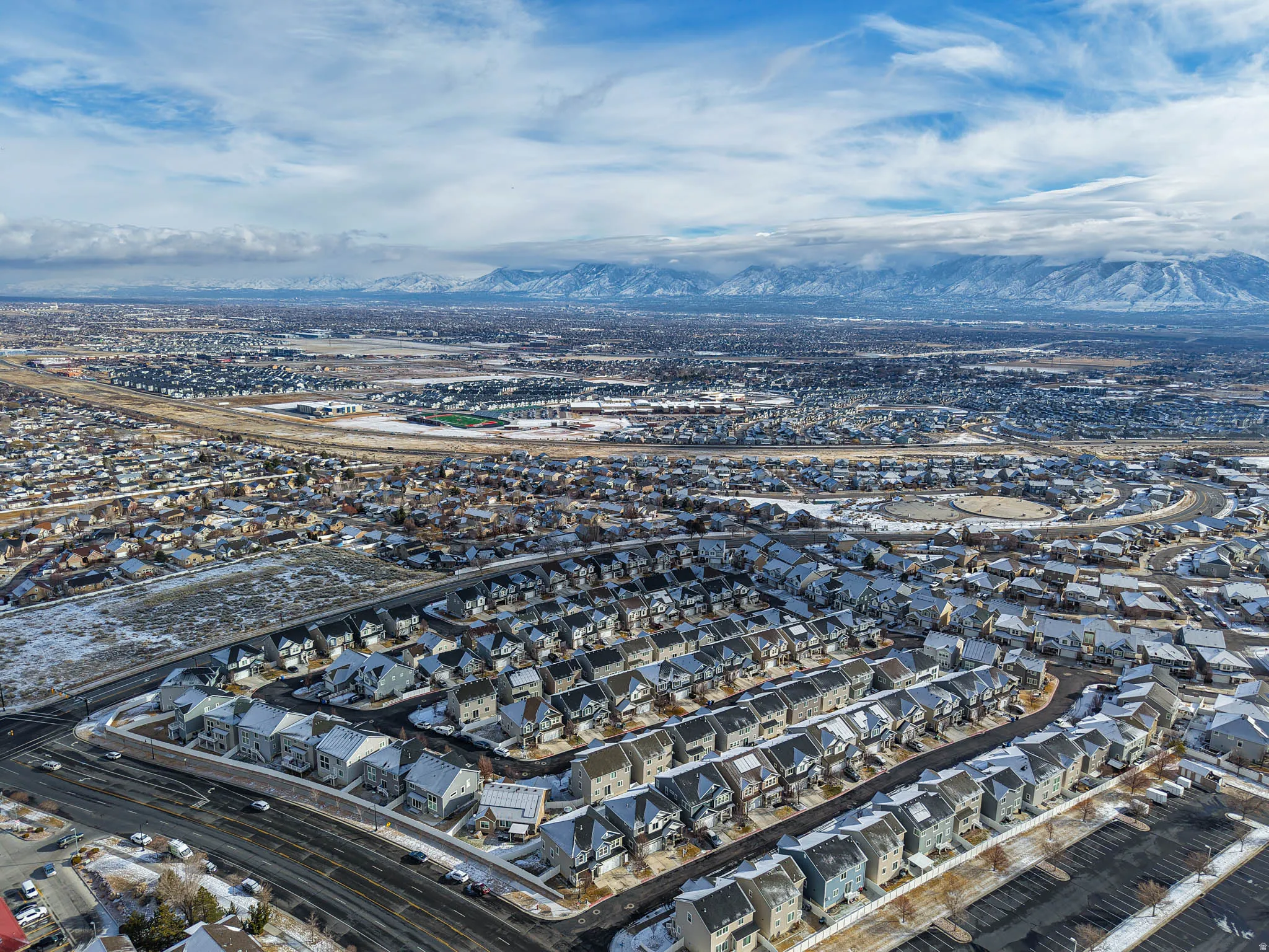 Aerial view of property's location with nearby suburban area and mountains