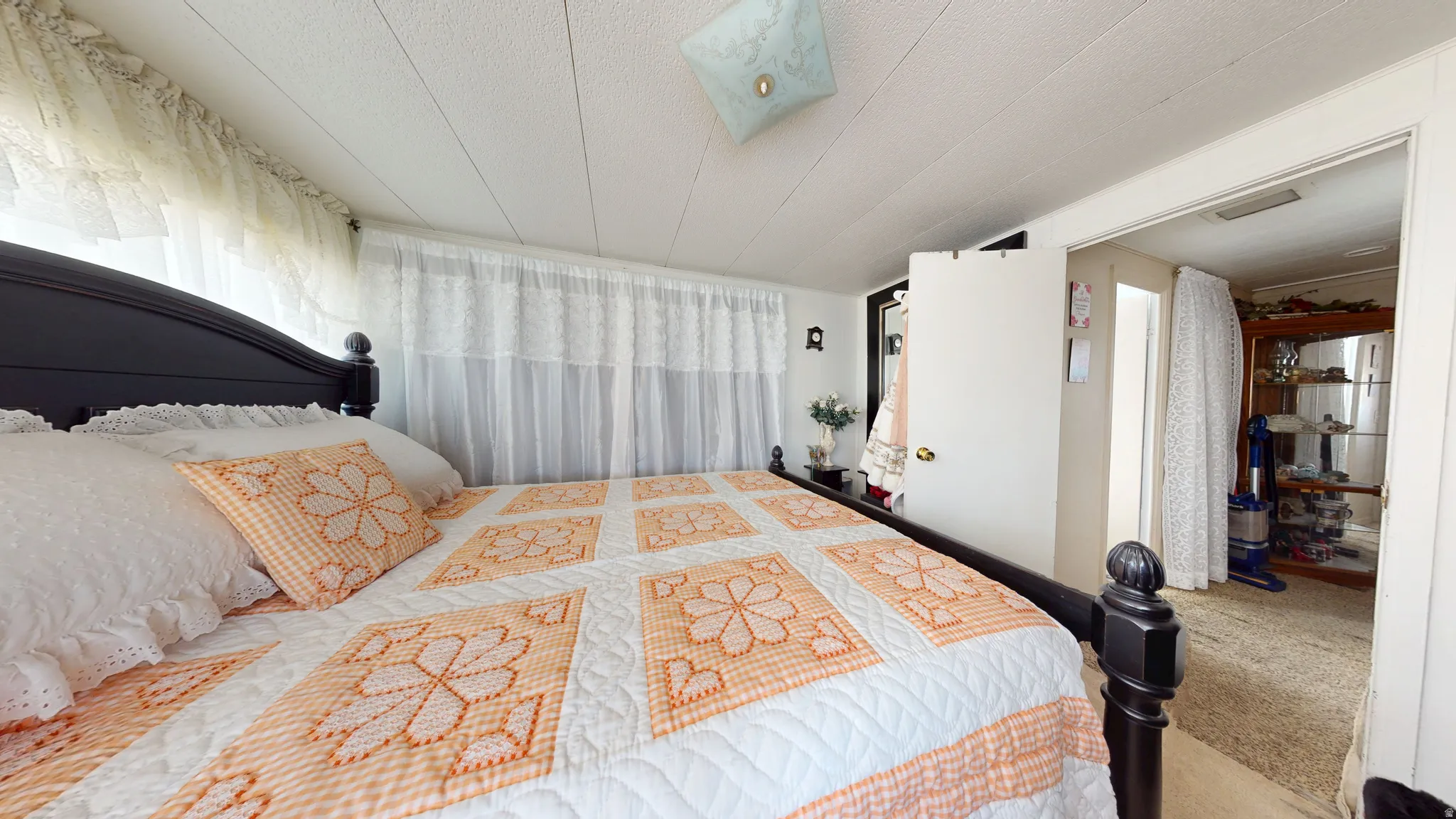 Bedroom with carpet floors and a textured ceiling