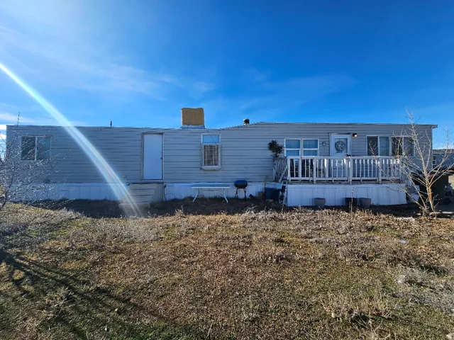 Back of house with a deck