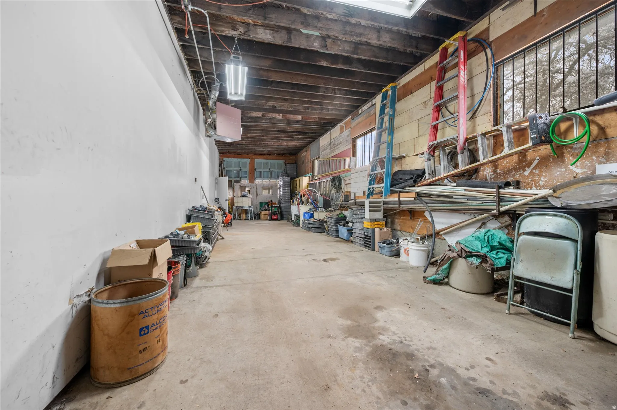 Garage for multiple company vehicles with garage doors on both ends for drive through option to back shed