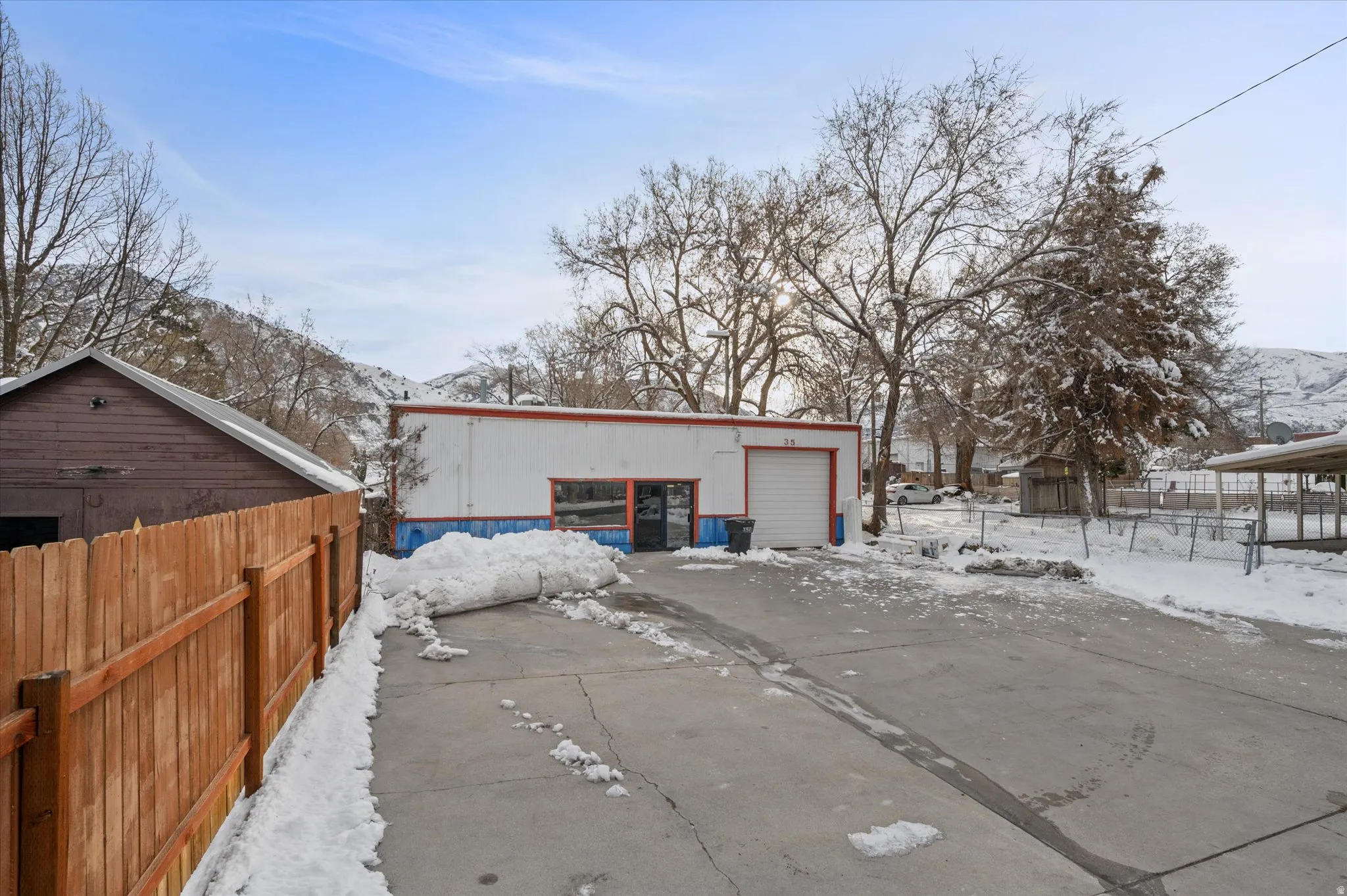 View of building front with garage and north fencing