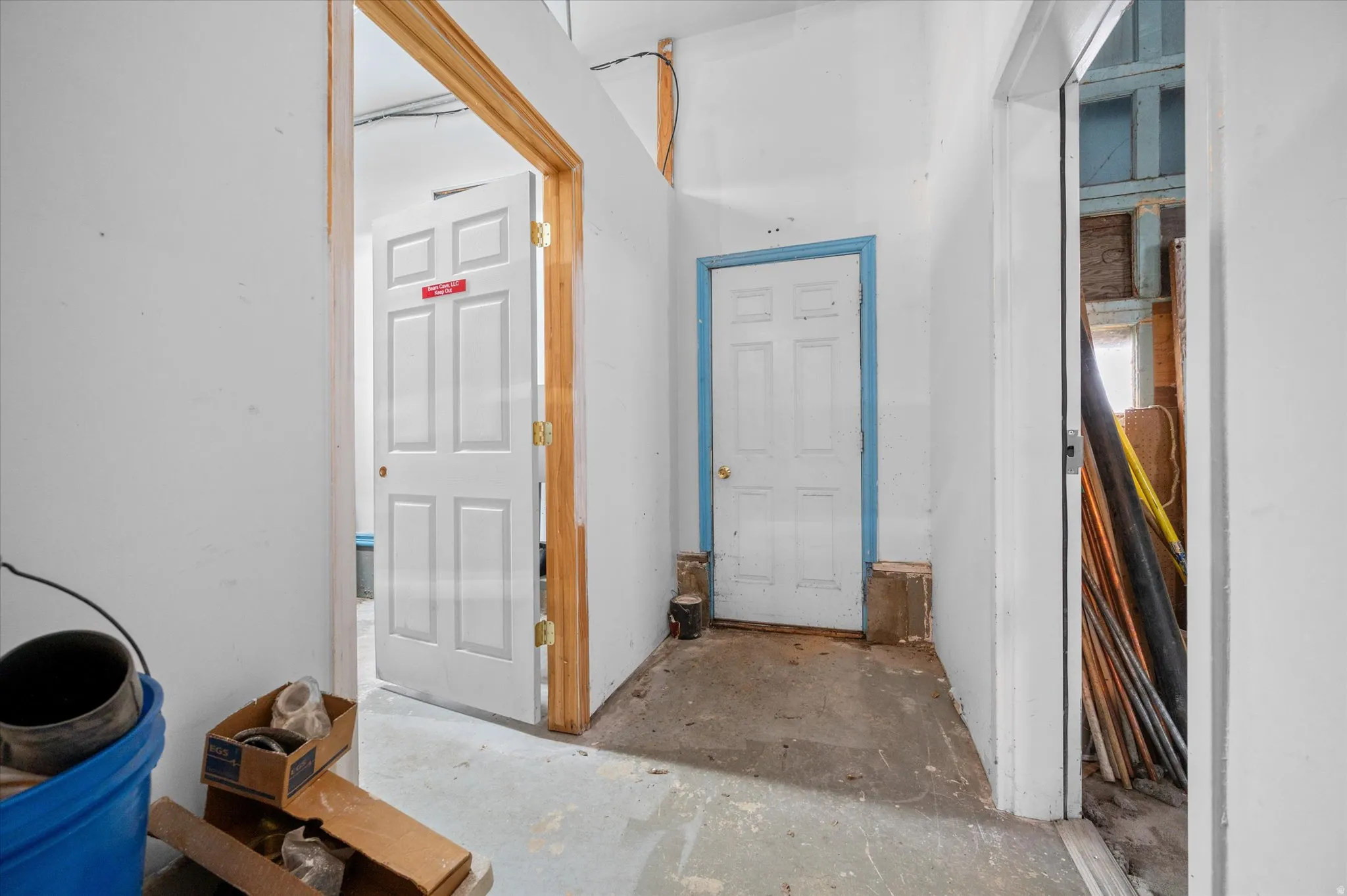 Hallway connecting supply room, backyard, and garage