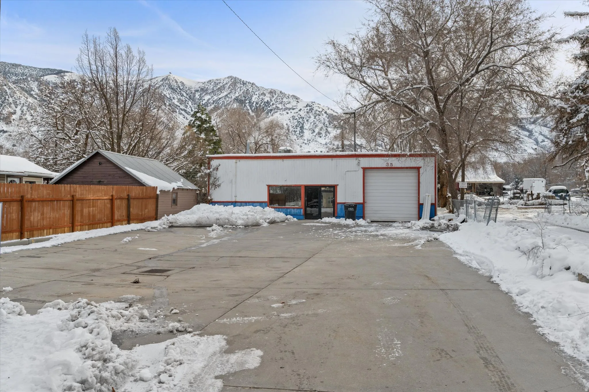View of large parking area, office entry and garage