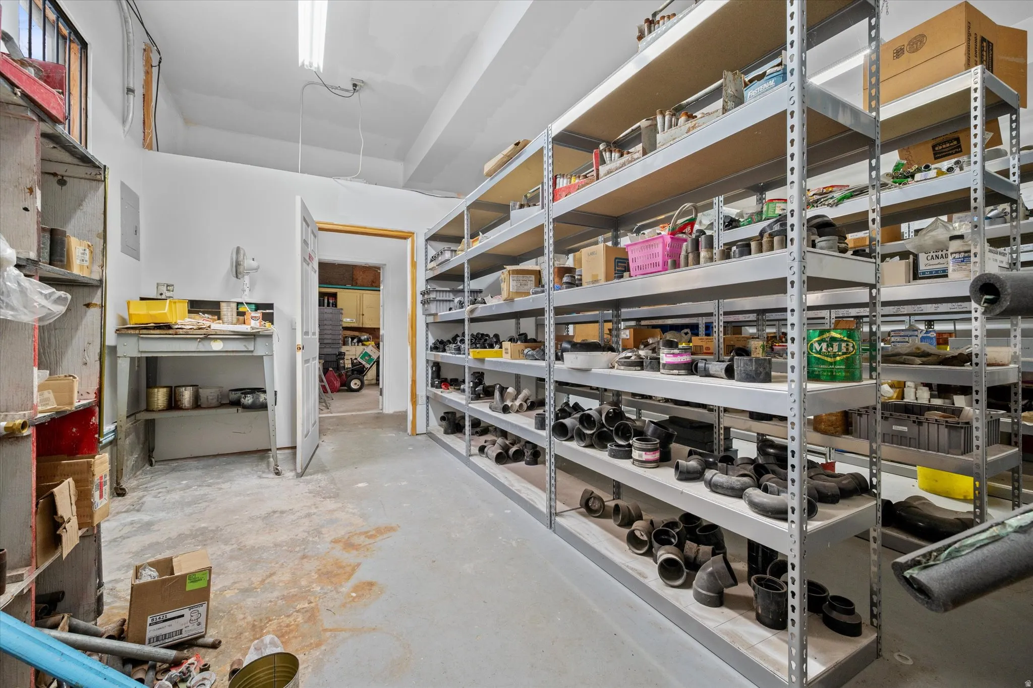 View of storage/supply room with access to garage