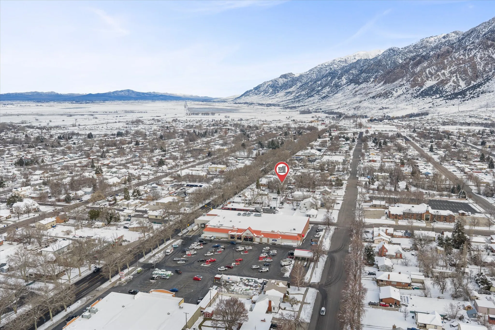 Aerial view with a mountain view and retail sale buildings nearby