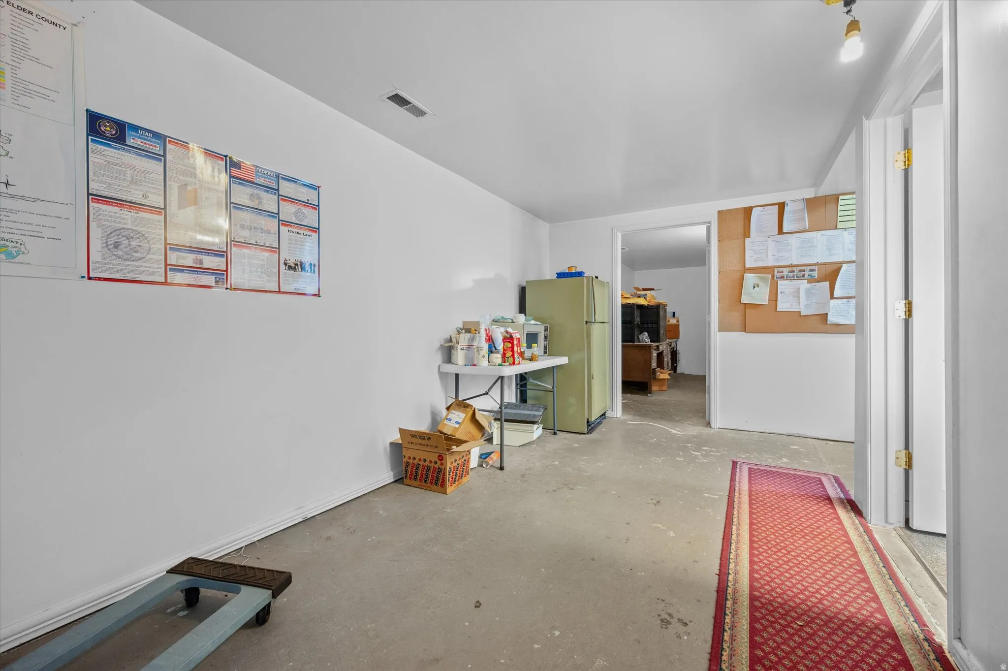 Kitchen area with fridge and microwave