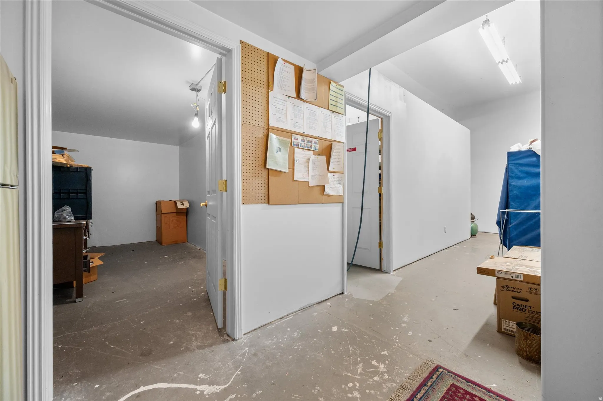 Hallway connecting conference, kitchen area, and storage rooms