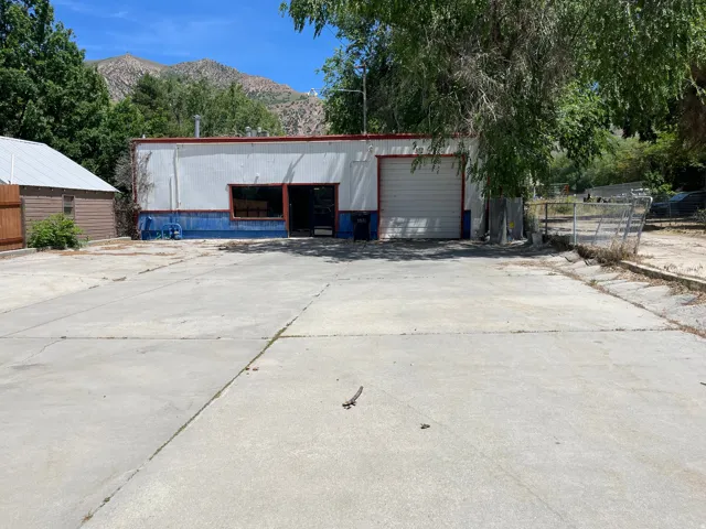 Building front with large parking lot