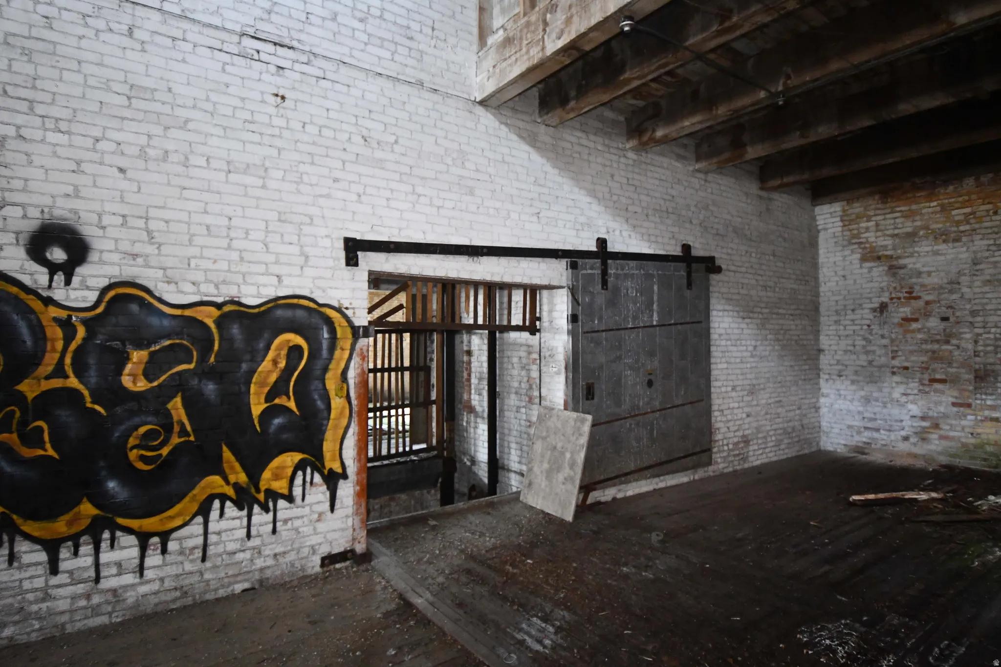 Detailed view of brick wall and a barn door