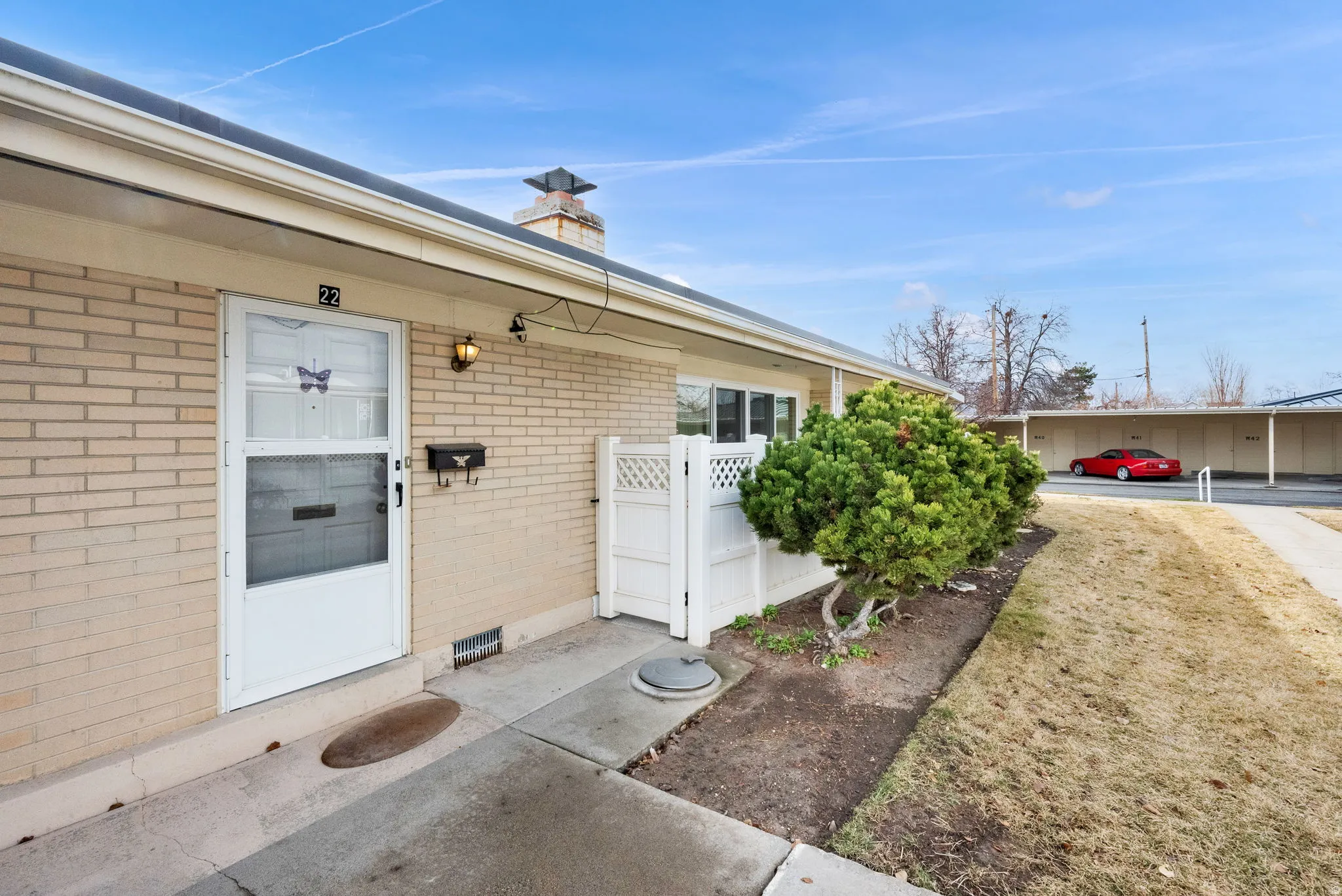 Doorway to property featuring brick siding and a chimney