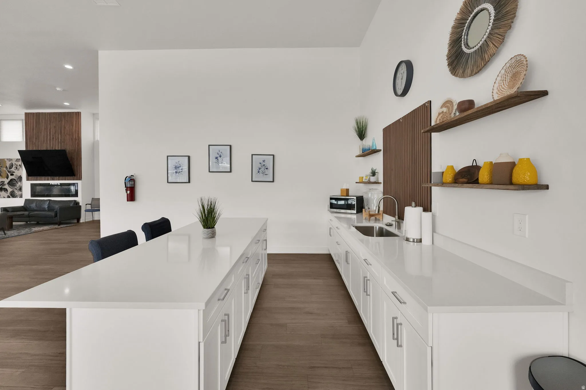 Kitchen with a breakfast bar area, dark wood-style floors, open shelves, white cabinets, and recessed lighting
