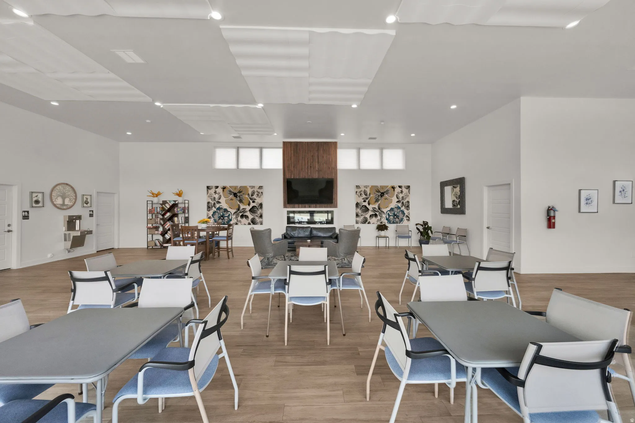 Dining room with light wood finished floors, a high ceiling, and recessed lighting