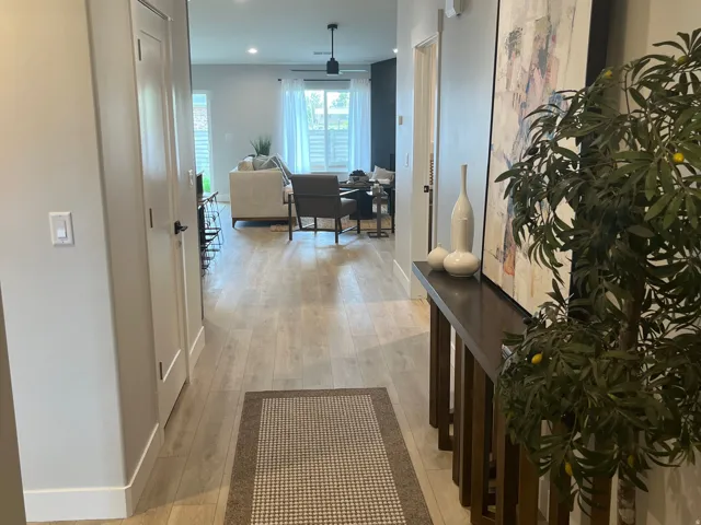 Corridor with light wood-style flooring and recessed lighting