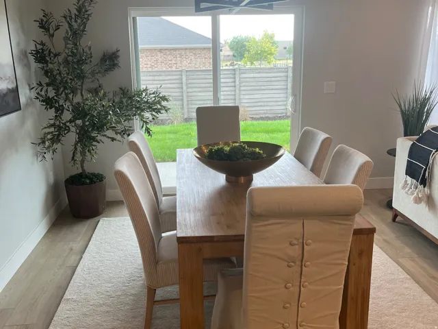 Dining space with light wood finished floors and suspended lighting