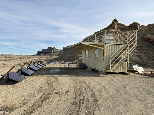 View of property exterior featuring solar panels and a mountain view