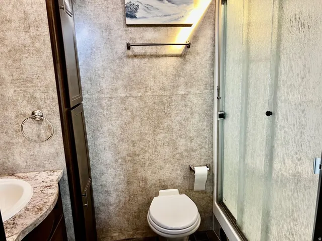 Full bathroom with vanity and a stall shower