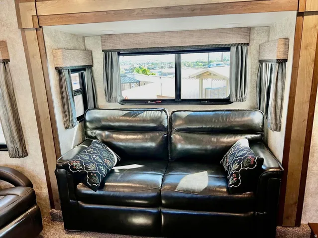 Living area with healthy amount of natural light and carpet floors