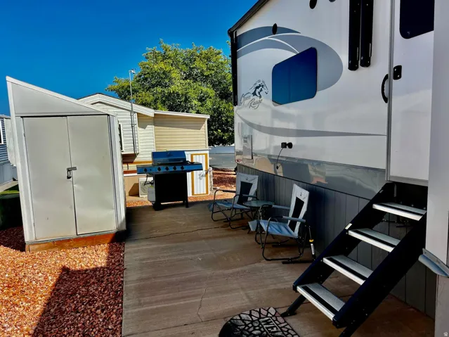 View of patio / terrace with a grill and a shed