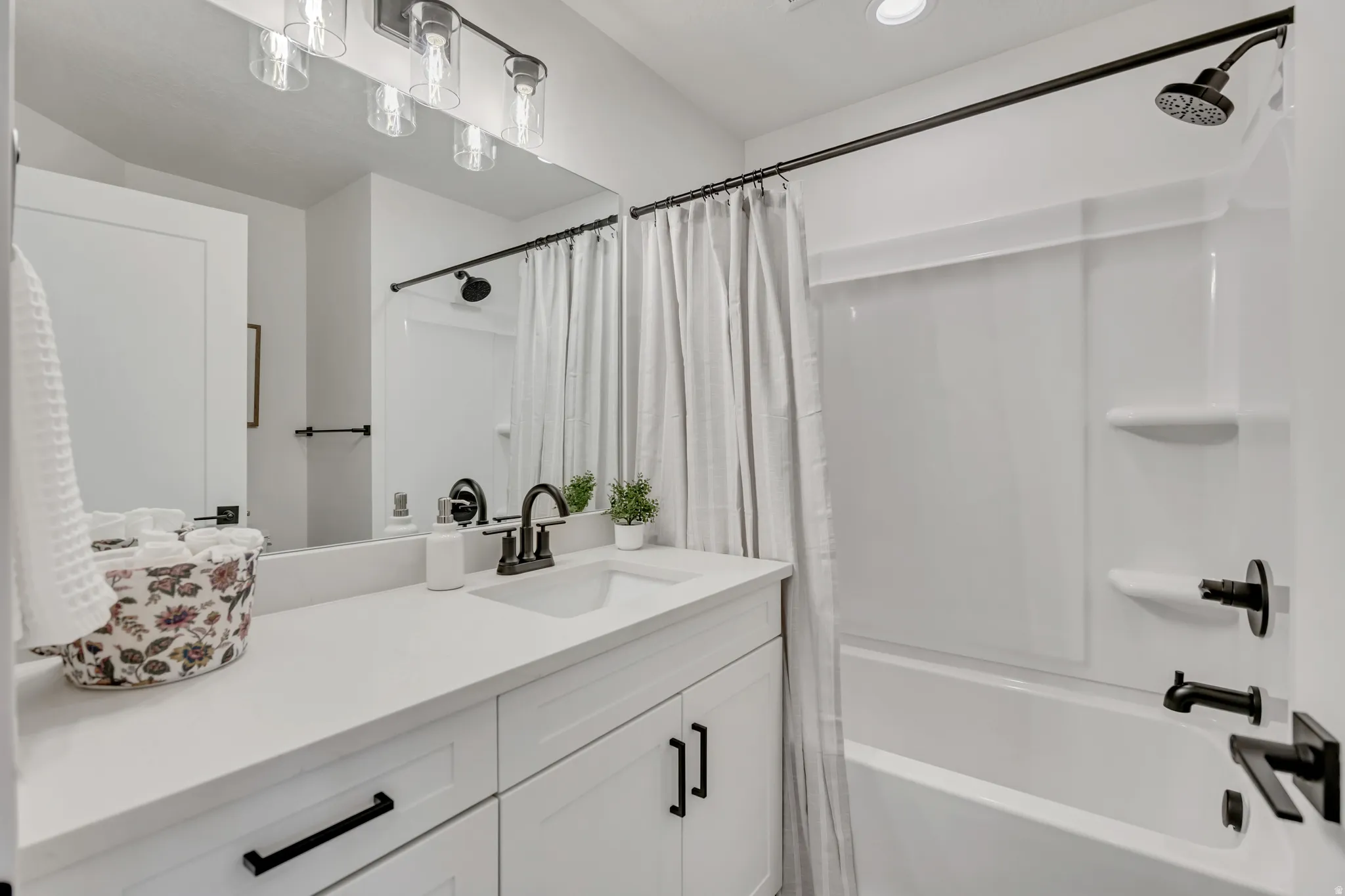 Full bathroom with vanity, shower / bath combination with curtain, and recessed lighting