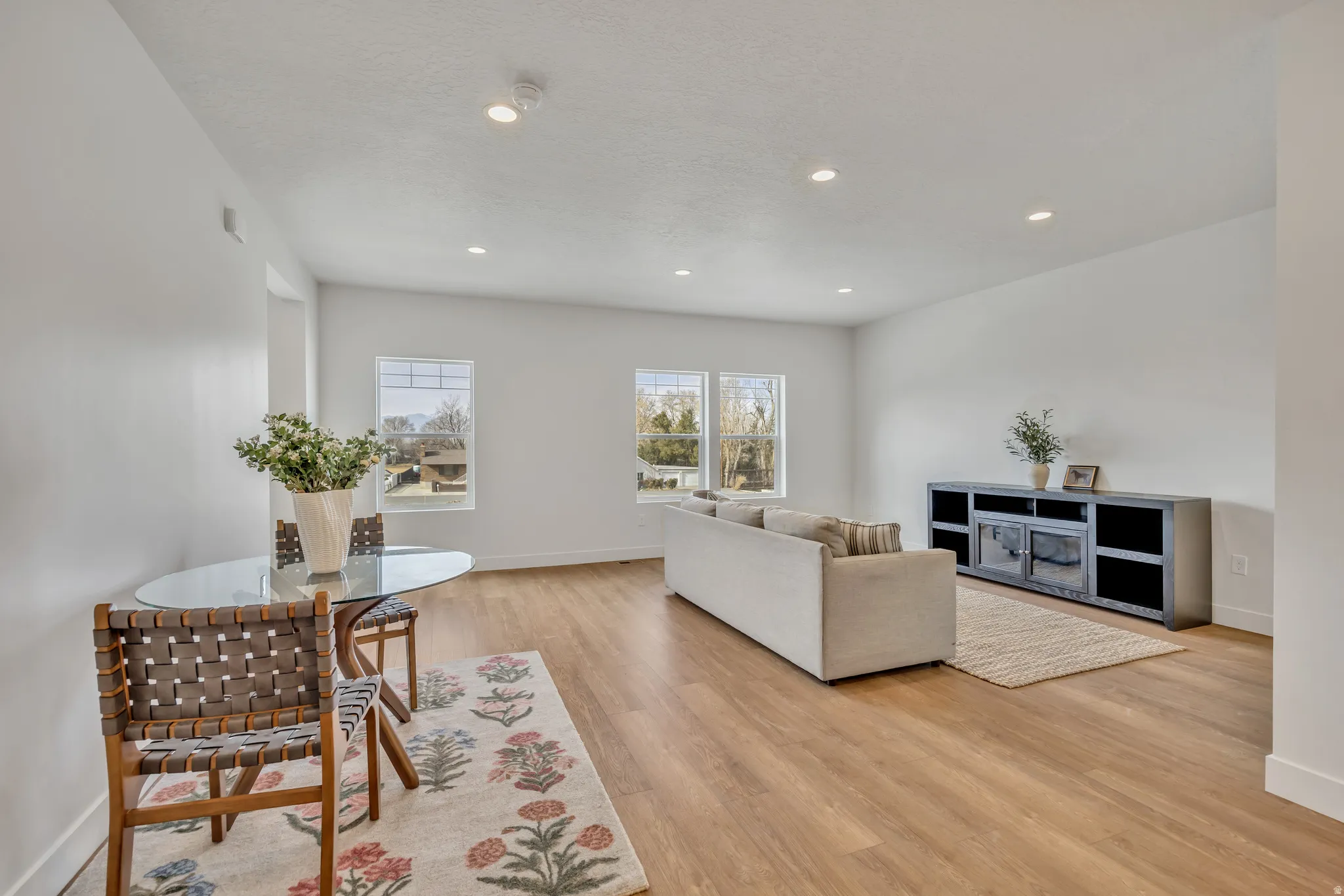 Living room featuring light wood-style flooring and recessed lighting