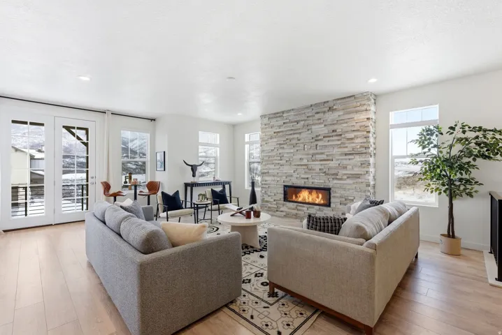 Living room featuring light wood-style floors and a fireplace