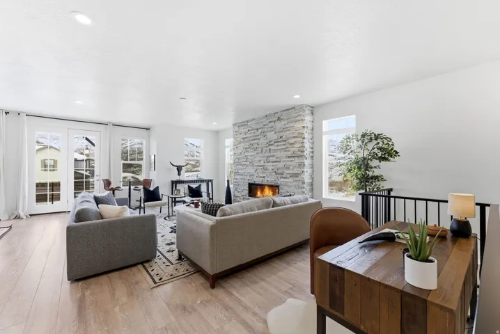 Living room with light wood-style flooring and a fireplace