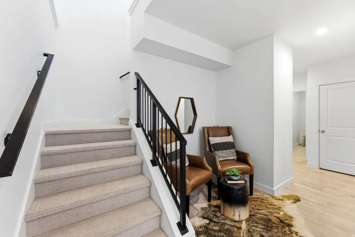 Staircase with baseboards and wood finished floors
