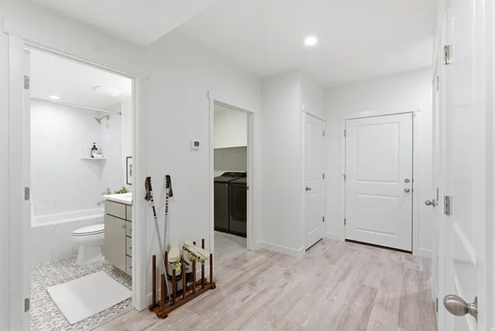 Full bath featuring vanity, washing machine and clothes dryer, shower / bath combination, light wood-style flooring, and recessed lighting