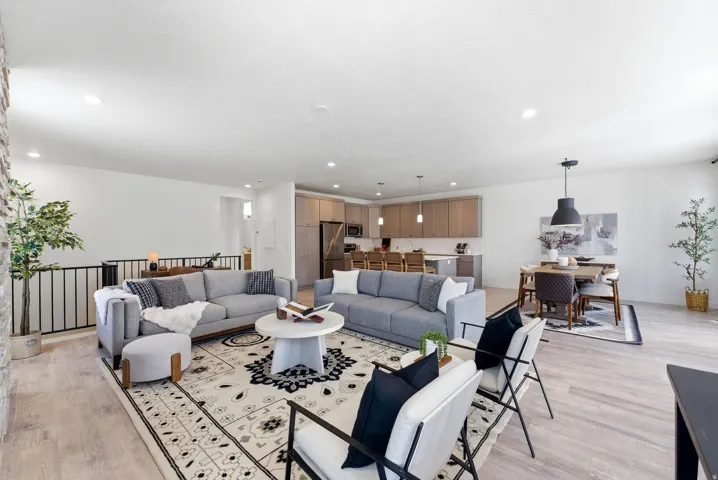 Living area with light wood-type flooring and recessed lighting