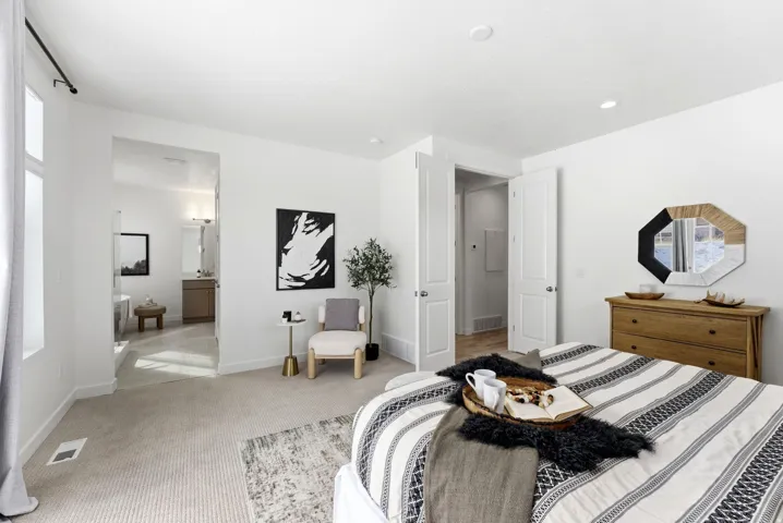 Bedroom with carpet floors and ensuite bath