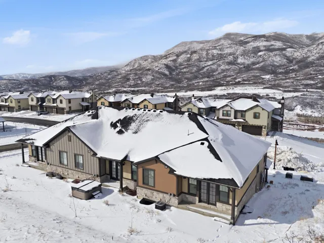 Snowy aerial view with a residential view and a mountain view