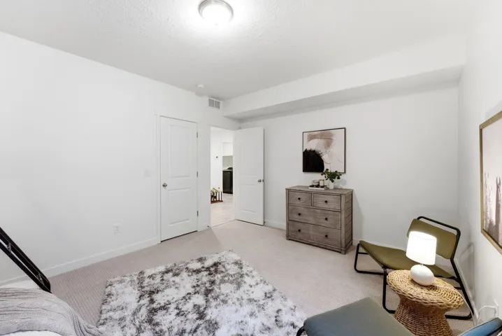 Bedroom with light carpet and baseboards