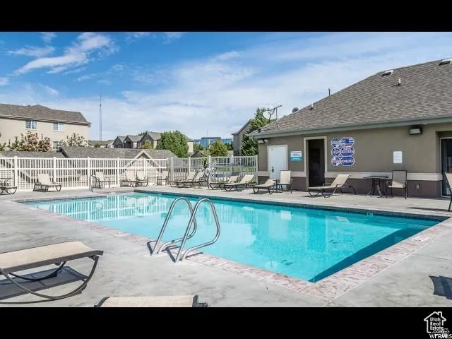 Community pool featuring a patio and a residential view