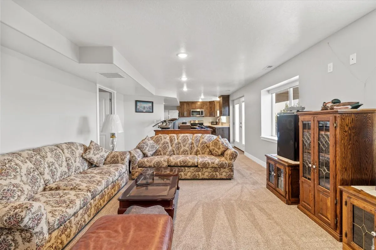 Living room with light colored carpet and recessed lighting