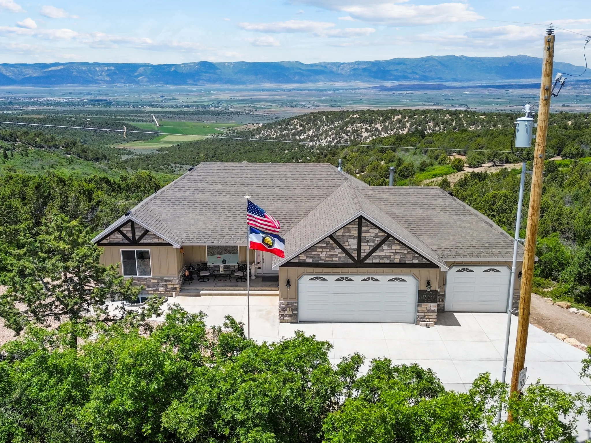 Aerial view of property and surrounding area with a mountain backdrop