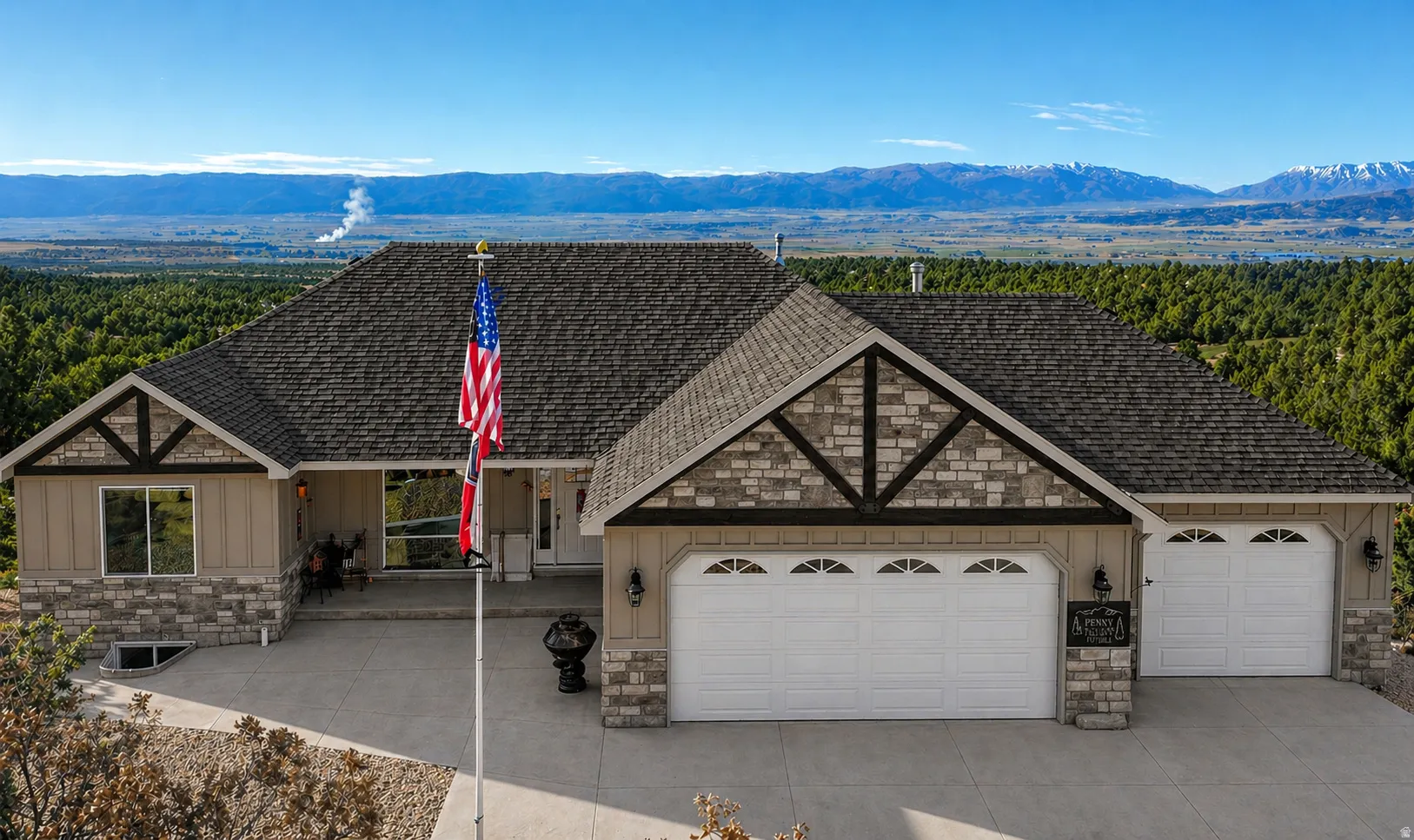 View of front of house featuring stone siding, a mountain view, and board and batten siding